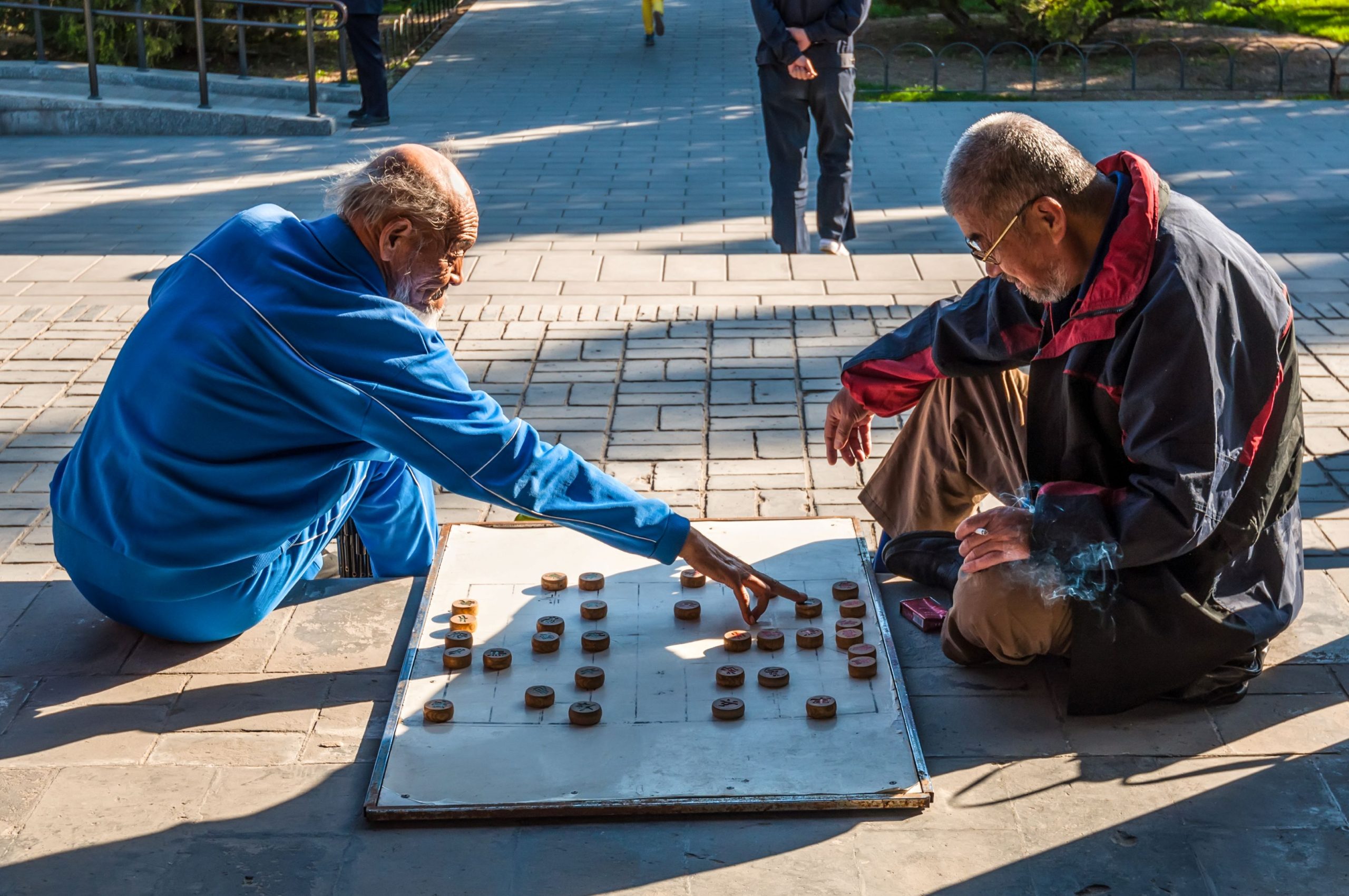 iStock 509724260 Elderly men playing Chinese chess xiangqi in a park outside the Temple of Heaven in Beijing China–CREDIT vale t for istockphoto scaled