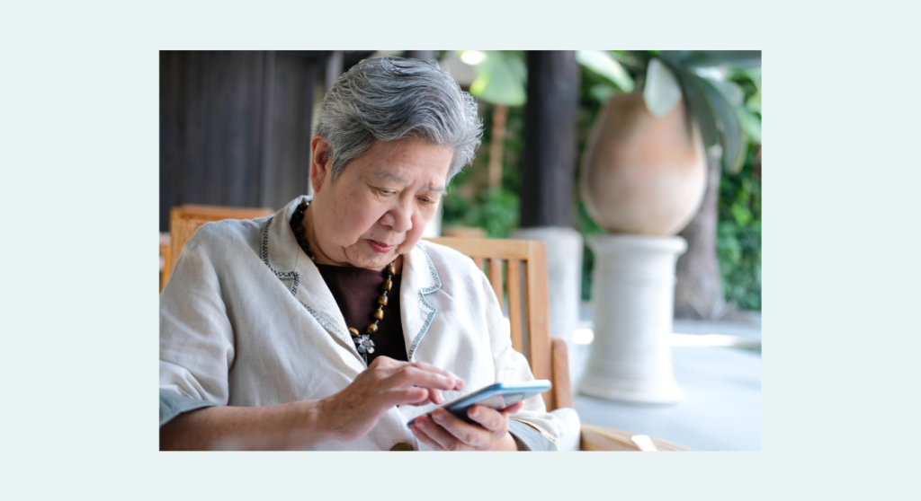 Canva stock photo–senior Asian female with mobile phone 2