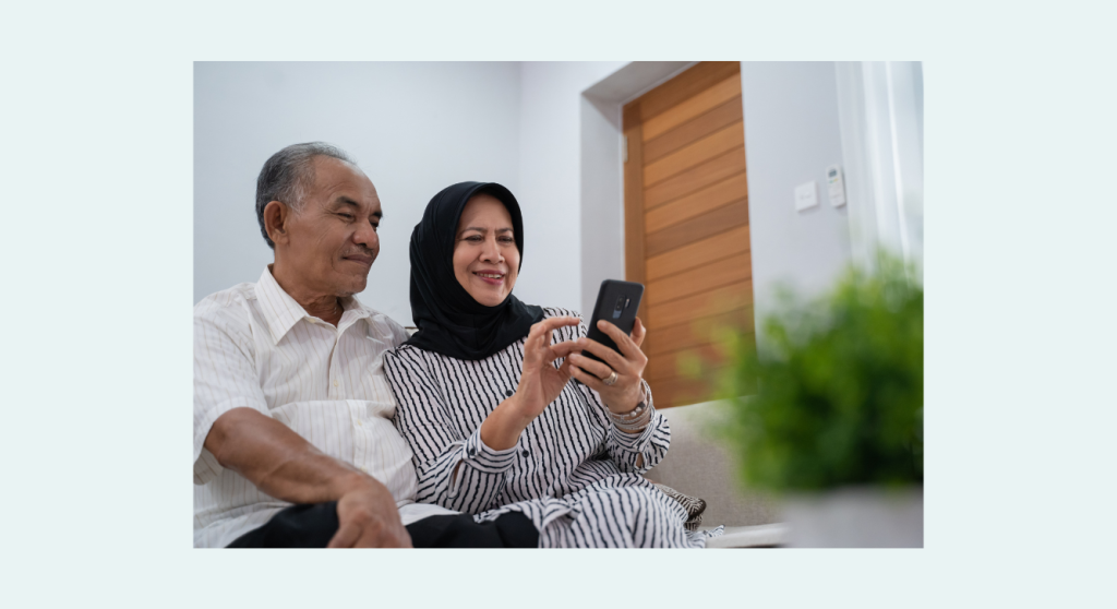 Canva stock photo–senior Muslim couple with mobile phone